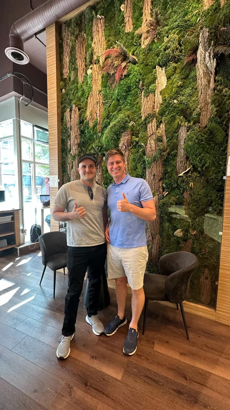 Rafael standing with another person in an office