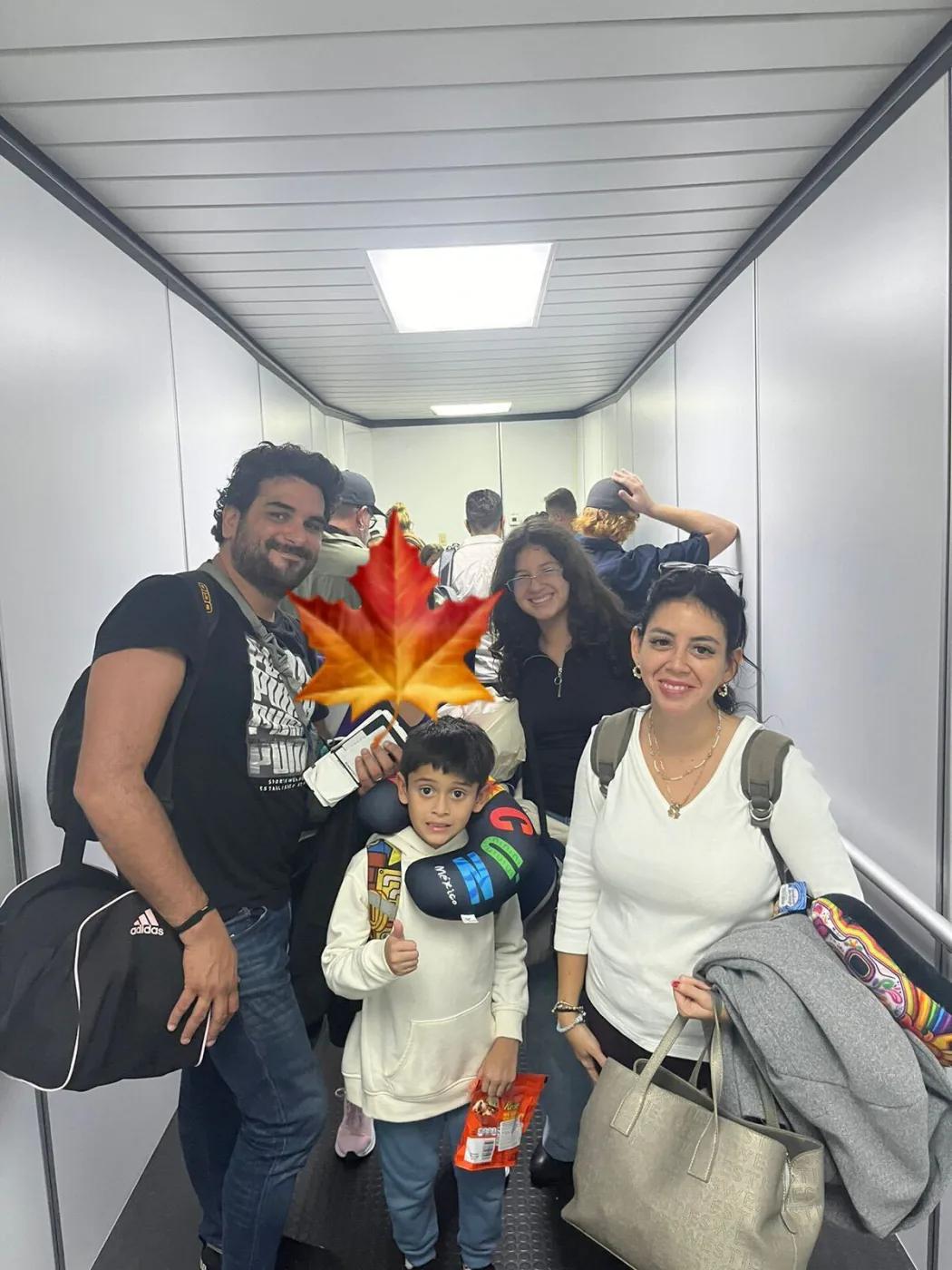 Ricardo with three other people in an airport jet bridge